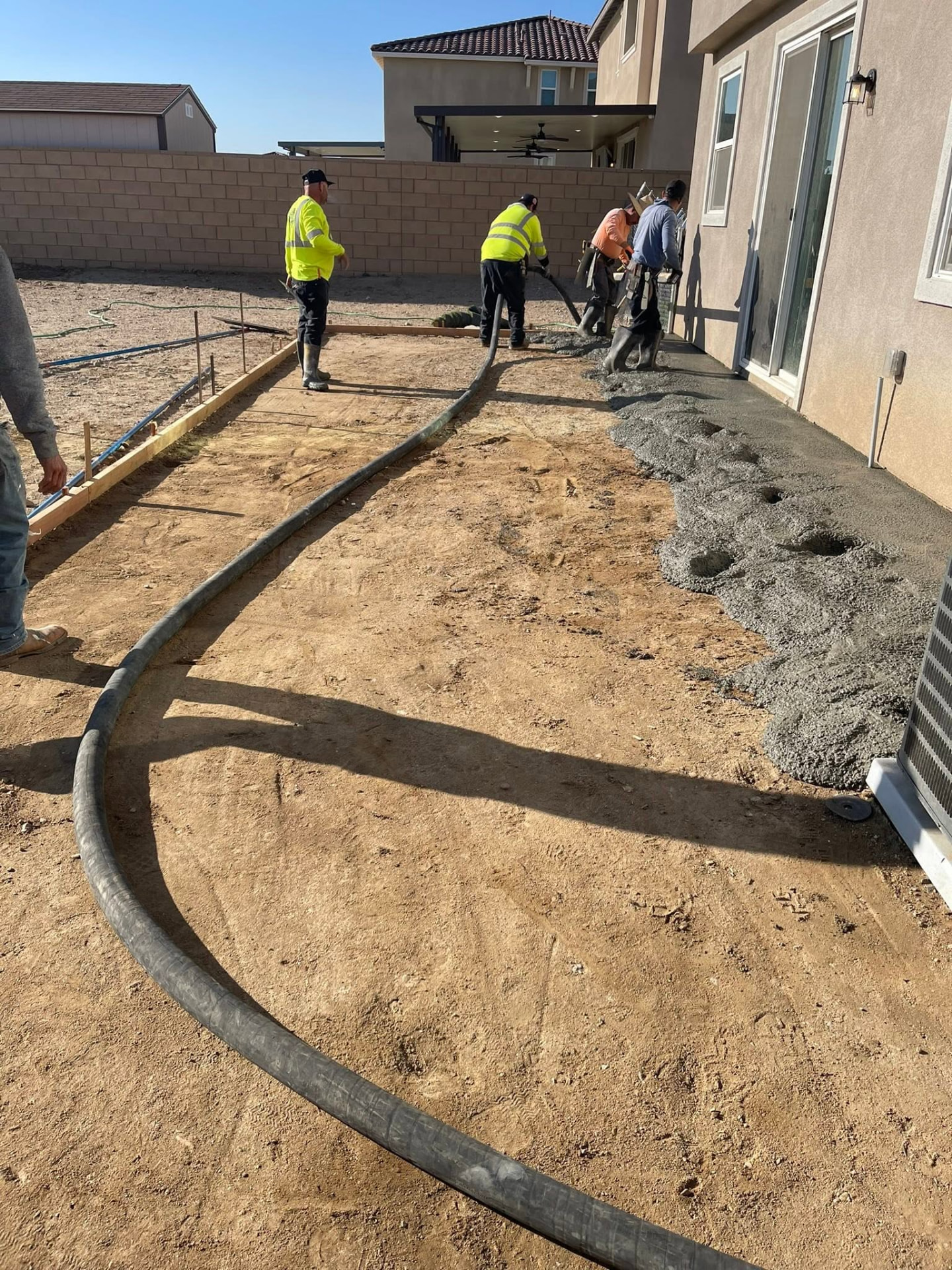 Crew installing concrete for a residential patio