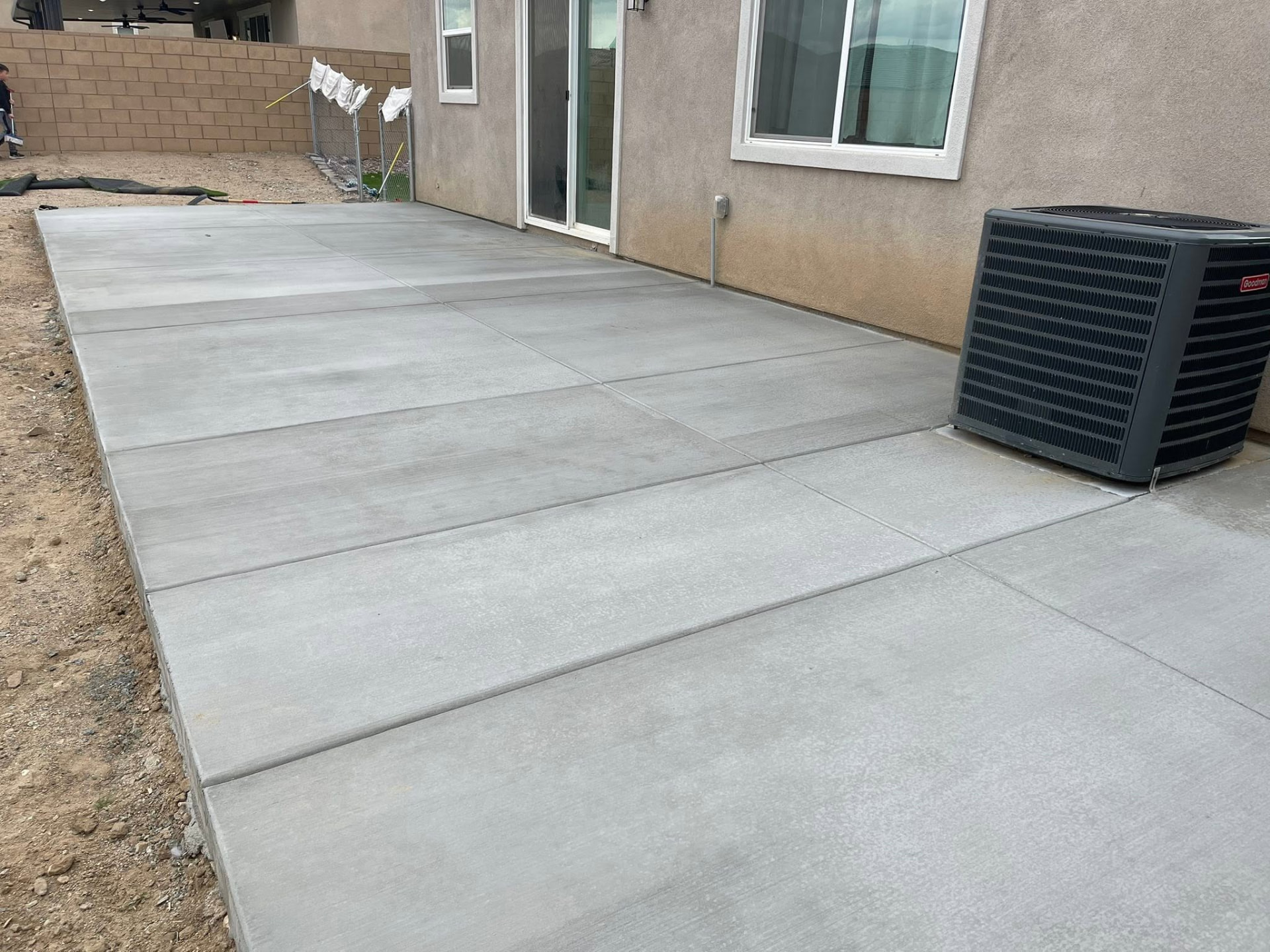 Completed concrete patio beside a home