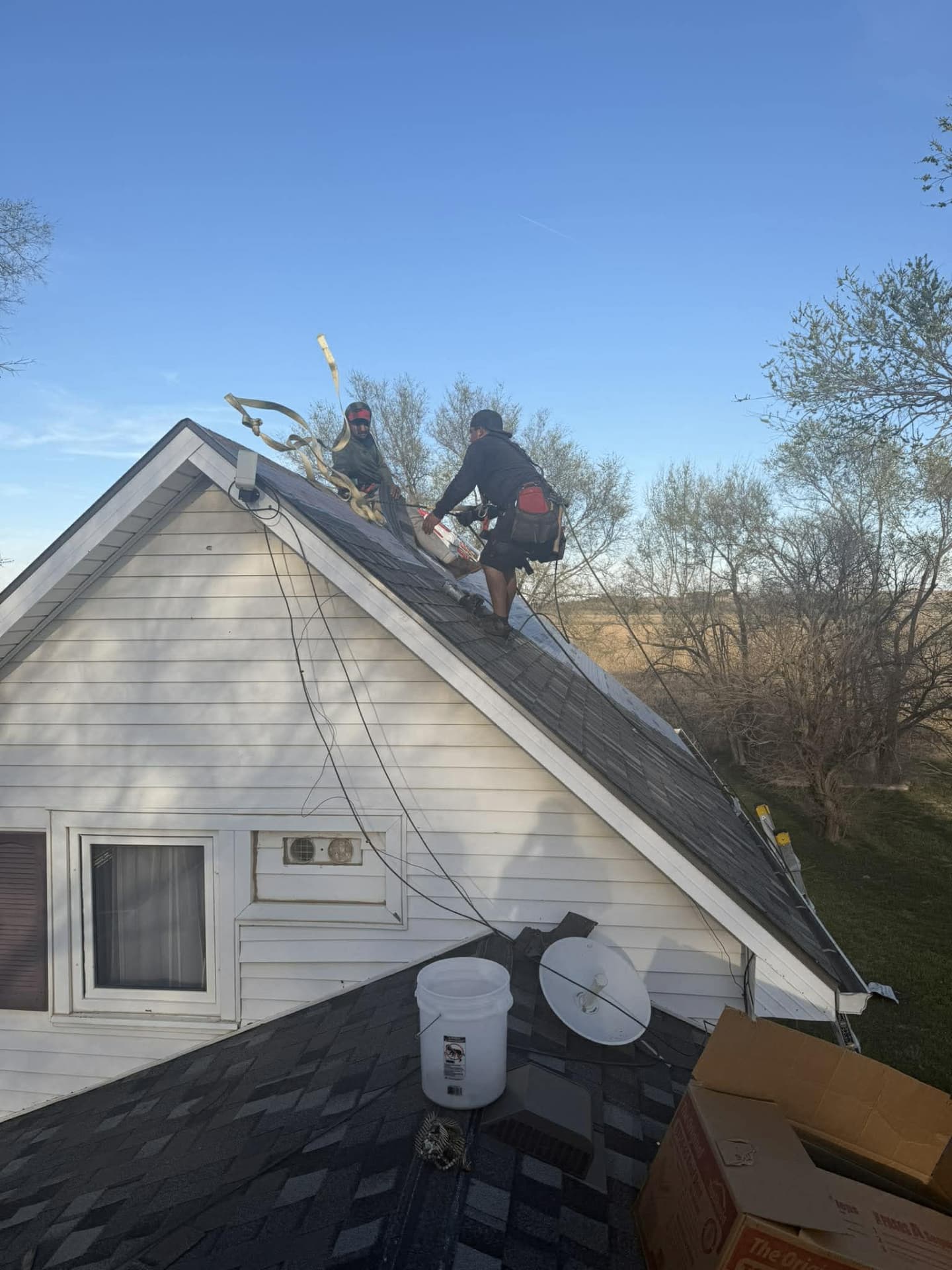 Roofing crew working together on a residential installation